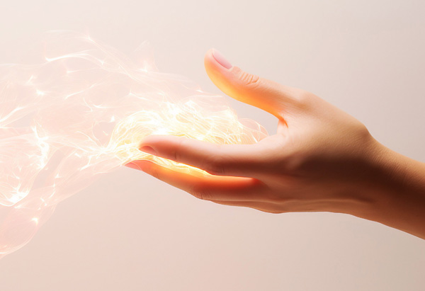 Main ouverte, énergie de lumière sort de la paume